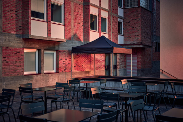 The black 3x3 m folding gazebo serves as an outdoor shelter on the terrace.